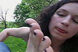 Girl taking off her boots and licking her feet