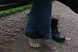 Girl taking off her boots and licking her feet
